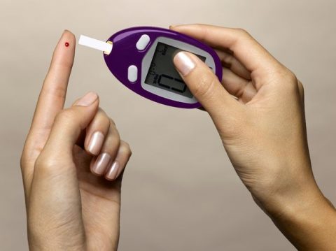 Woman-using-diabetes-test-kit